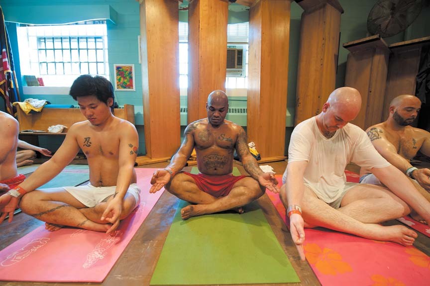 To make room for their yoga class, inmates upend the pews in the jail's Redemption Chapel and unroll their mats on the floor. From left: Chong Mounce, Calvin Faulk and Jay Stelter. - SCOTT ELMQUIST
