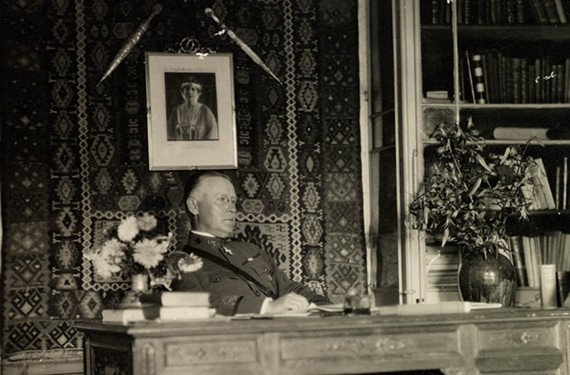 At his Red Cross office in Romania, Henry Watkins Anderson works below a portrait of Queen Marie — not his fiancée, Ellen Glasgow. - VIRGINIA HISTORICAL SOCIETY