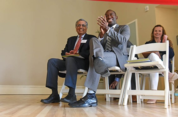 T.K. Somanath, head of the Richmond Redevelopment and Housing Authority, and Mayor Levar Stoney sit together at the ribbon-cutting ceremony for the Highland Park Senior Apartments. - SCOTT ELMQUIST