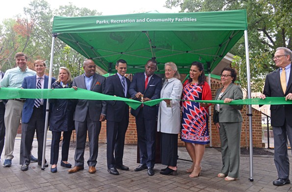 Mayor Levar Stoney cuts the ceremonial ribbon Sept. 27 to reopen Monroe Park after a 22-month restoration. Among other dignitaries he is flanked by Michael Rao, VCU president, and Alice McGuire Massie of the Monroe Park Conservancy. - SCOTT ELMQUIST