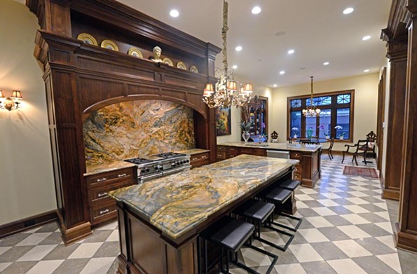 The 2710 Monument Ave. kitchen has a backsplash and countertops of large slabs of quartzite, a gorgeous naturally occurring stone that brings flair to the kitchen and an earthy appeal. - SCOTT ELMQUIST