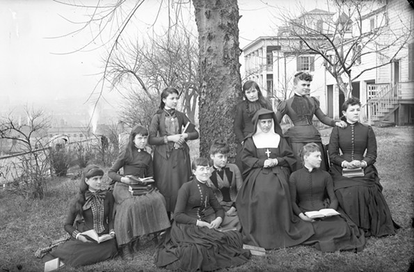 A sister and students at the Monte Maria Academy, a private school operated by the cloistered Sisters of the Visitation of Mary, posed in this undated photo in the late 19th or early 20th century, on the southwest ridge of Church Hill looking toward Shockoe Bottom. The convent later moved to Hanover County. The Richmond Hill retreat center now occupies the complex. - THE VALENTINE
