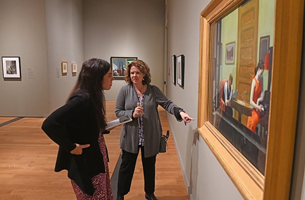 Amanda Dalla Villa Adams looks at “Room in New York” with Sarah Powers, a curatorial research specialist. - SCOTT ELMQUIST