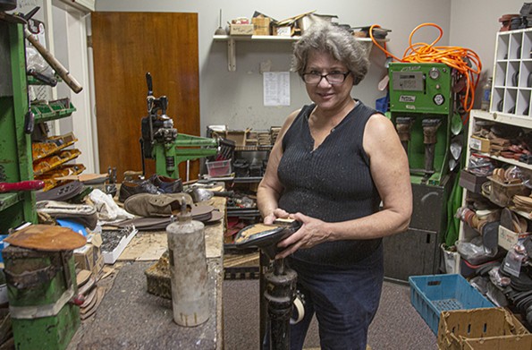 Cynthia Kalfoglou, a cobbler and the proprietor of Gus’s Shoe Repair at 528 E. Main St., has shifted to boot repairs and mending zippers during the pandemic. - SCOTT ELMQUIST