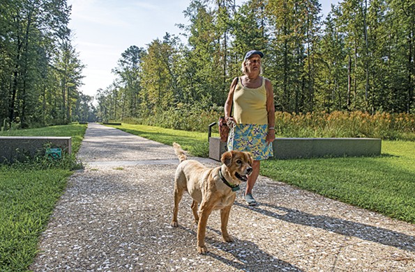 Vivian Lee Messner, a long-time Colonial Beach resident, walks Barney along the Time Trail at the Monroe birthplace. - SCOTT ELMQUIST