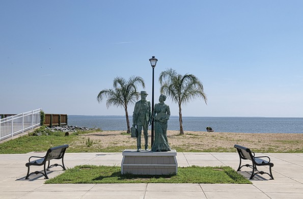 A sculpture depicting two Gilded Age vacationers greets beach goers on the waterfront at Colonial Avenue. - SCOTT ELMQUIST