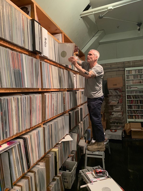Rollins digs through his massive home library of records. - HEIDI MAY