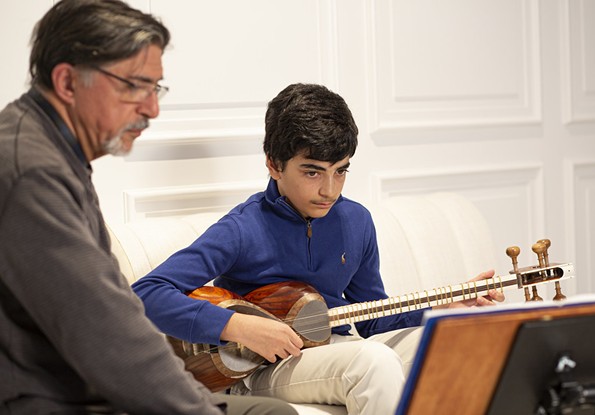 Kazem Davoudian of Sterling, Virginia is an experienced ustad (master artist, in Farsi) of Iranian classical music. He is teaching Alexander Sabet of Washington, DC, how to play the tar, a traditional long-necked string instrument. - KATY CLUNE