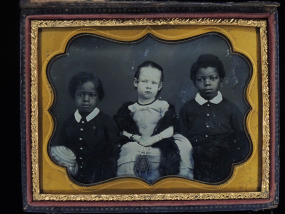 Two enslaved children, Andy and Willie, flank a white child, Hendra, in a detail from the work "Andy, Mary E. Hendra, and Willie" (1850), a daguerreotype from the collection of Dennis O. Williams on display at VMFA through May 8, 2023.