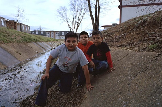 Kids play in a ditch in an area known as La Mancha in Southwood in a photo by Jose Henriquez Jr.