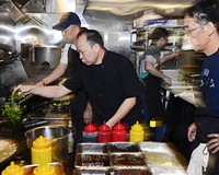 In his busy Short Pump kitchen, Chang demonstrates for his staff exactly how his dishes should be prepared.