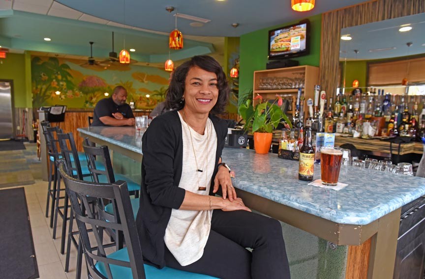 Carena Ives serves a variety of local beer at Carena’s Jamaican Grill: “Putting ‘craft’ in front of it makes it this other thing.” - SCOTT ELMQUIST