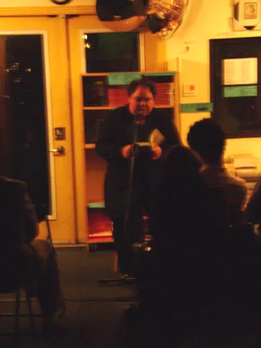 A fuzzy photo of Anna Quon reading. A fuzzy photo of Anna Quon reading.