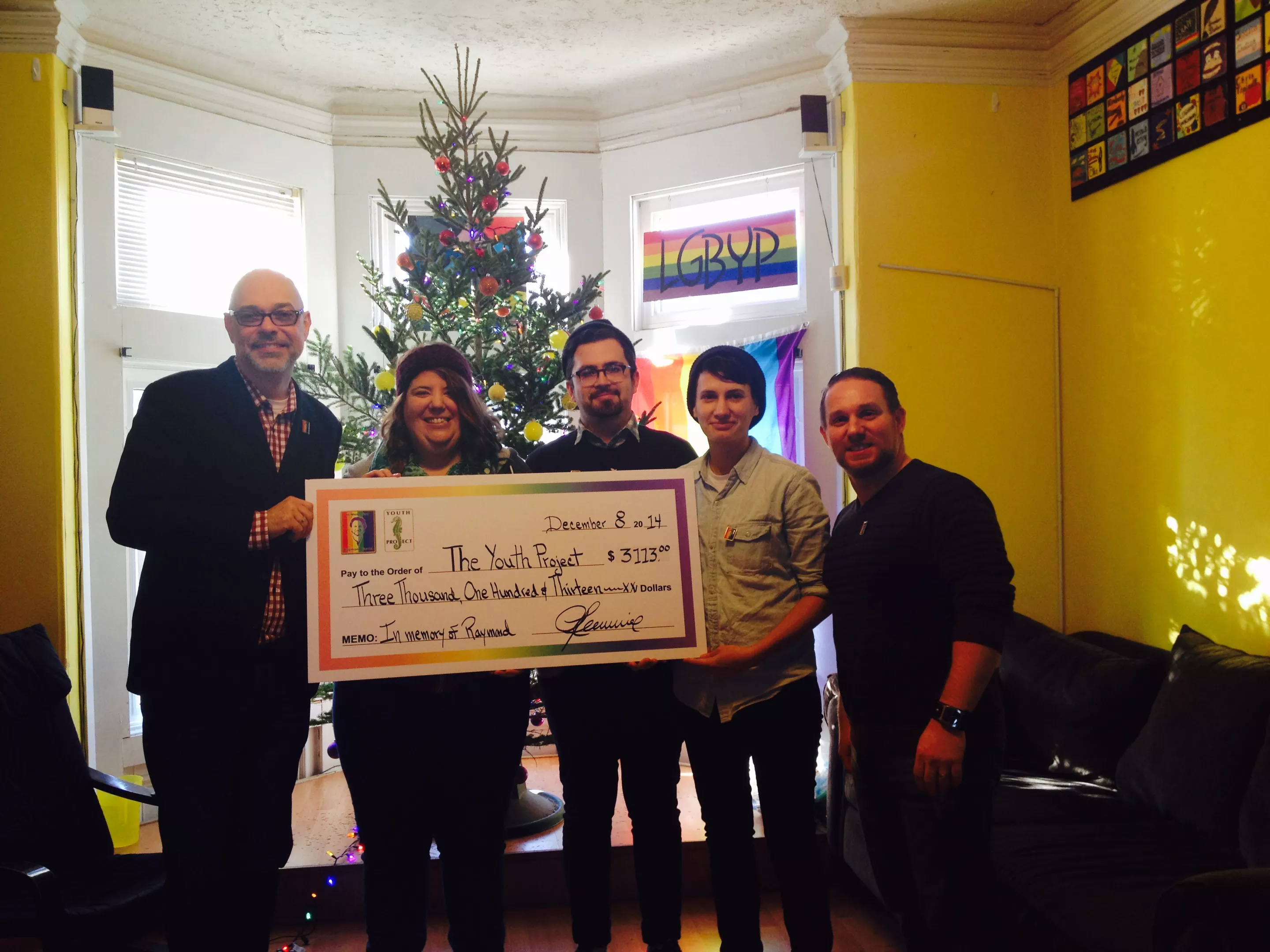 Darren Lewis (left) presents the cheque to Youth Project staff Kristen Sweeney, Adam Myatt, Dori Palmiere, and board member Patrick Daigle. - SHEENA JAMIESON