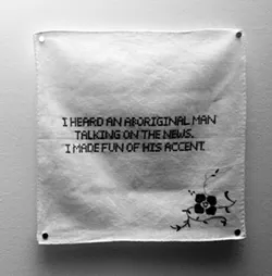 One of Tamara Huxtable's hankies embroidered with the confession "I heard an aboriginal man talking on the news. I made fun of his accent."