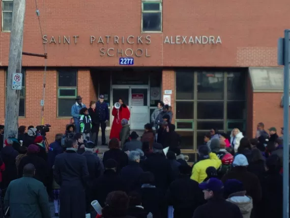 Reverend Rhonda Britton of the Cornwallis Baptist Church rallies north end community members at the school site, last Sunday.