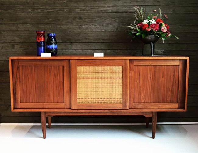 Refinished walnut credenza, featuring three sliding doors, adjustable/removable shelving, weave centrepiece, and tapered legs. - VIA FACEBOOK