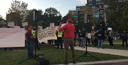 Garvey speaks to a row of police officers and counter-protestors who are probably not even listening to him. - SANDRA C. HANNEBOHM