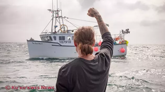 Mi'kmaw lobser harvester Colton Willis greets non-Indigenous harvesters while setting traps in St. Mary's Bay near Saulnierville, NS on September 17. - KU'KU'KWES NEWS, STEPHEN BRAKE