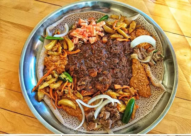 Ethiopian meat and chickpea stews atop injera bread. - ALI'S PLACE FACEBOOK