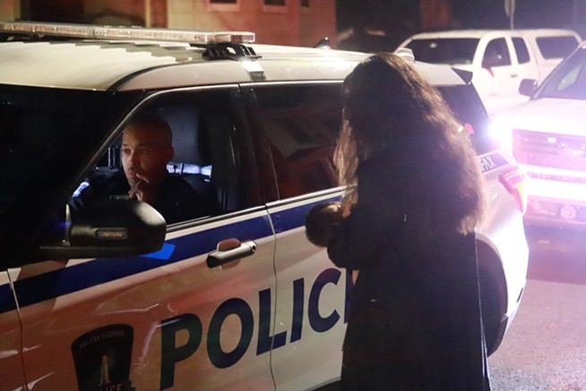 Sakura Saunders speaks with an HRP officer the second time they show up on Friday night. - VICTORIA WALTON/THE COAST