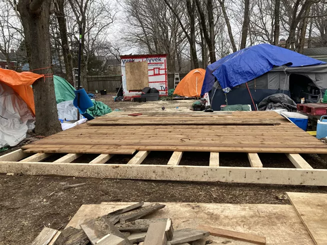 A wooden deck is being built at People's Park as a "kitchen floor" to keep food off the muddy ground. - THE COAST