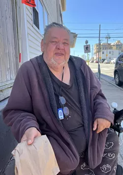 Souls Harbour guest William Rose with a packed lunch on Thursday outside the shelter, which feeds more than 100 people a day. - THE COAST