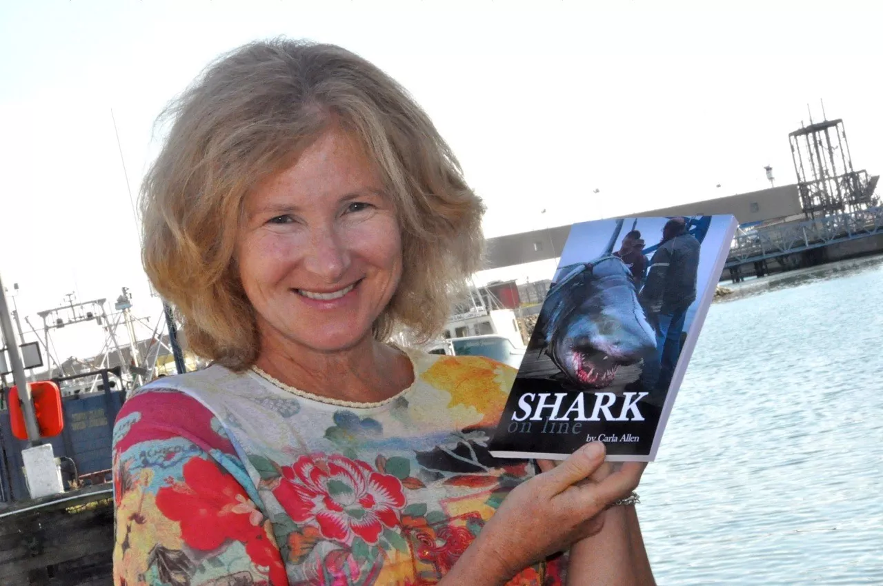 Carla Allen poses with her book in 2012. Buy Shark On Line here - PHOTO BY TINA COMEAU AND THE YARMOUTH VANGUARD