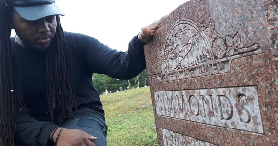 Music producer and filmmaker Keke Beatz pays respects to his grandmother’s grave. - FRANCELLA FIALLOS