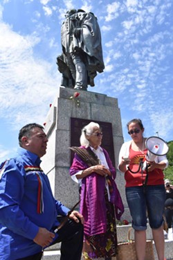 Chief Morley Googoo, Mi'kmaw elder Isabelle Knockwood and event organizer Suzanne Patles stand beneath the statue. - THE COAST
