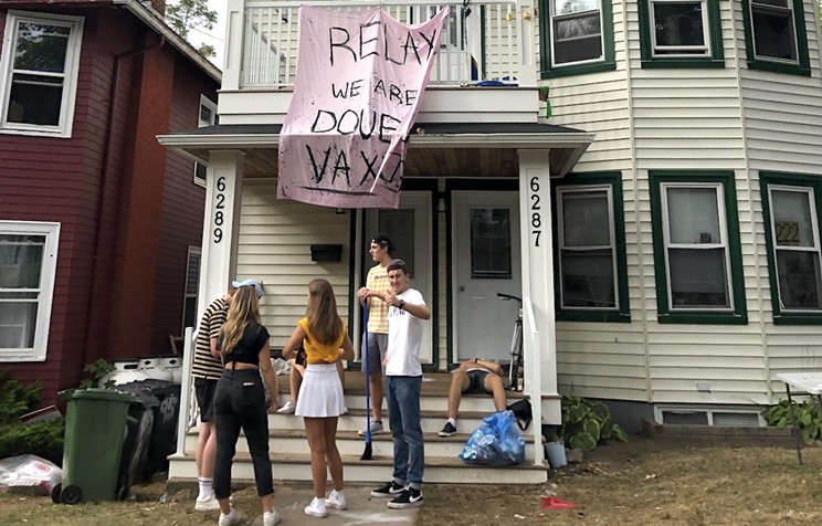 Getting in the HoCOVID spirit, students give their own public COVID notification Saturday at a party for Dalhousie's homecoming.