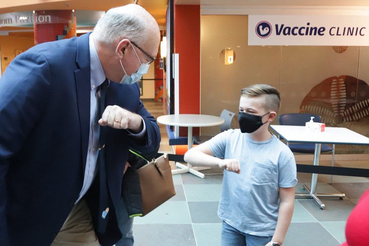 Dr. Robert Strang greets eight-year-old Jack Woodhead after he received the COVID-19 vaccine at the IWK clinic on Dec 1.