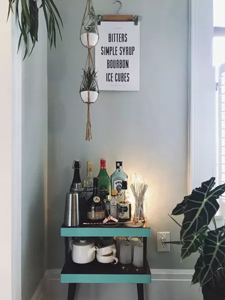 “Our bar was just a little shitty TV table of fake wood, like every side table in the '70s was made of, that I spied in the garbage room at my friend’s apartment. I sanded down the sides, toll painted the sides minty green, a friend made that old fashioned print and we built a little bar around it.”