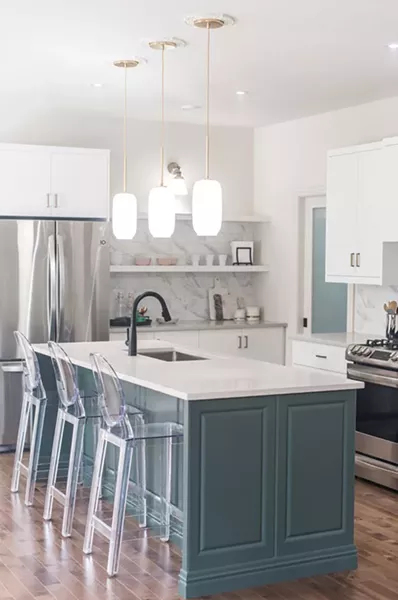 The clear stools are a visual distraction from the majorly detailed, hardware-heavy island - MATT MCMULLEN