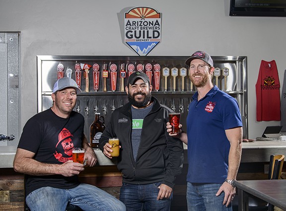 Matt Gordon from Sentinel Peak (left), Es Teran from Borderlands (center) and Taylor Carter of Sentinel Peak inside their taproom at 330 S. Toole Ave., next to Rocks and Ropes. The two brewing companies joined to form Arizona first co-op, Voltron Brewing.