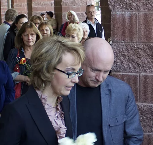 Gabby Giffords and Mark Kelly placed a wreath of flowers at a memorial for those slain on Jan. 8, 2011