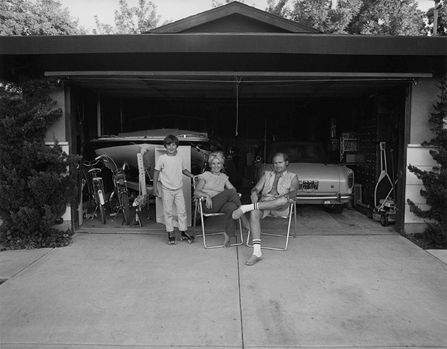 Our house is built with the living room on the back, so in the evenings we sit out front of the garage and watch the traffic go by, from Suburbia, 1972 gelatin silver print, © Bill Owens, courtesy Etherton Gallery