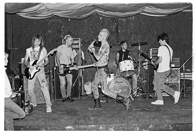 "Civil Death at The Backstage on 4th Ave., May 13, 1983. Civil Death was a Tucson band formed by singer Lenny Mental, drummer Nick Johnoff and guitarist Zach Hitner. My friend Paul Young, who has since passed away, joined in late 1983 on guitar.  Paul used to let me get on his shoulders during shows to take photographs above the crowd. Pictured is Paul Young on guitar, Johnny Glue on bass, Lenny Mental on vocals, Nick Johnoff on drums and Zach Hitner on guitar." - ED ARNAUD