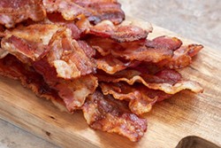 bigstock-cooked-greasy-bacon-on-a-wood--296855854.jpg