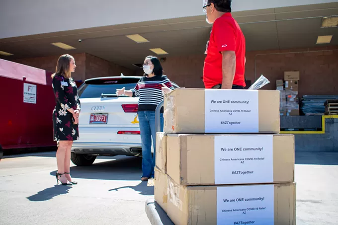 Oro Valley resident Fang Fung speaks with Oro Valley Hospital Chief Administrative Officer Erinn Oller after donating 5,000 Level 1 face masks to the hospital. Fung is a member of Chinese American COVID-19 Relief AZ, a group of more than 300 volunteers raising funds to supply PPE to hospitals across the state. - LOGAN BURTCH-BUUS, TUCSON LOCAL MEDIA