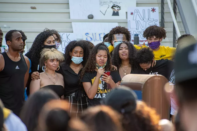 15-year-old Janel Drummer shares her personal experiences with racism while being comforted by her sister and supporters during Wednesday’s demonstration. - LOGAN BURTCH-BUUS