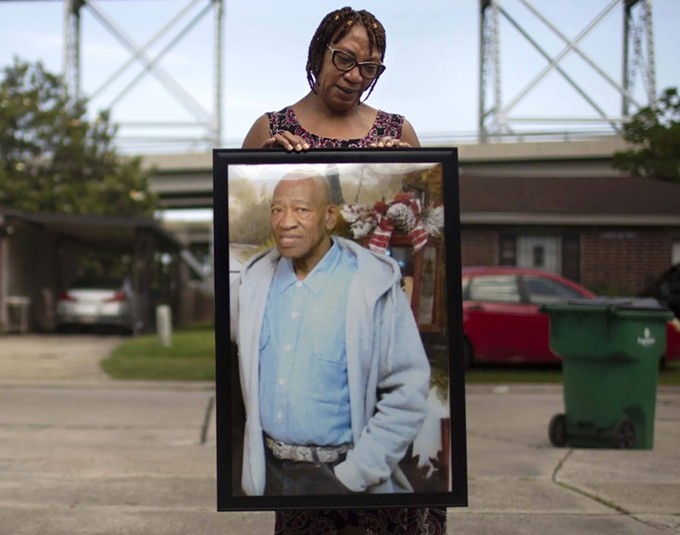 Terry Rogers holds a photo of Michael Williams, her brother, in front of her home in Bridge City, Louisiana, on May 17, 2020. (Kathleen Flynn/ProPublica)