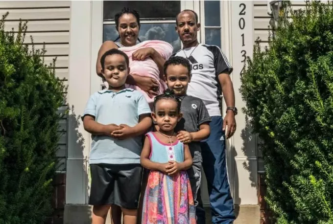 Gebrish Weldemariam, who was laid off by an airline catering company that later received government aid, with his family outside their Virginia home. (Dee Dwyer for ProPublica)