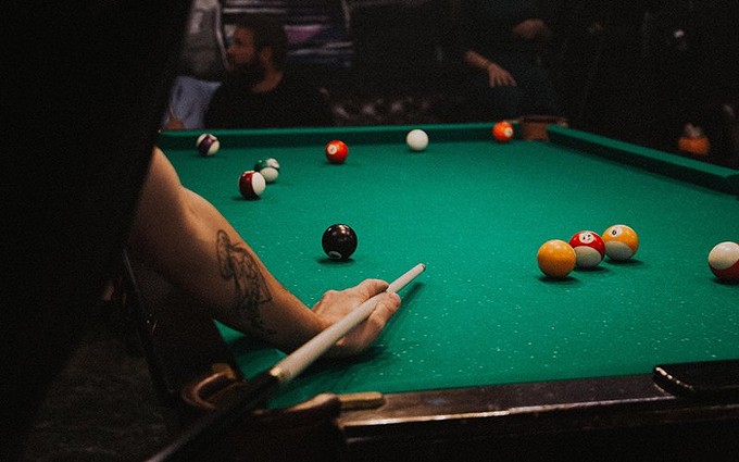 Parlor games like darts and pool are prohibited under social distancing rules. Jamie Bates, manager of Bull Shooters Billiards & Sports Bar in Phoenix, says "that hurts us." - PHOTO BY KLARA KULIKOVA/CREATIVE COMMONS