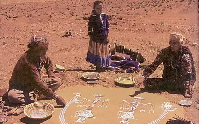 A young patient watches a medicine man, right, and helper prepare a sandpainting as part of her healing ceremony in 1980. - PHOTO COURTESY OF THE NATIONAL LIBRARY OF MEDICINE, NAVAJO AREA INDIAN HEALTH SERVICE TODAY, IHS