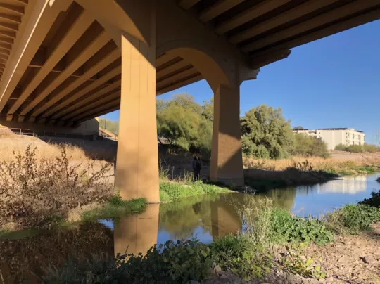 The Santa Cruz River flows underneath the Cushing Street Bridge in Tucson, Ariz. The restored flow is a result of Tucson Water’s Santa Cruz River Heritage Project. Since June 24, 2019, Tucson Water has released reclaimed water into the riverbed from a discharge pipe near West Silverlake Road.