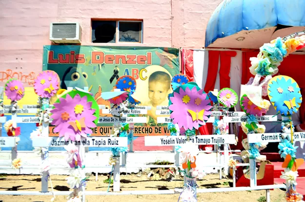 Shrine outside the ruins of the ABC Day Care for 49 toddlers who died in a fire seven years ago. - MARIA INES TARACENA