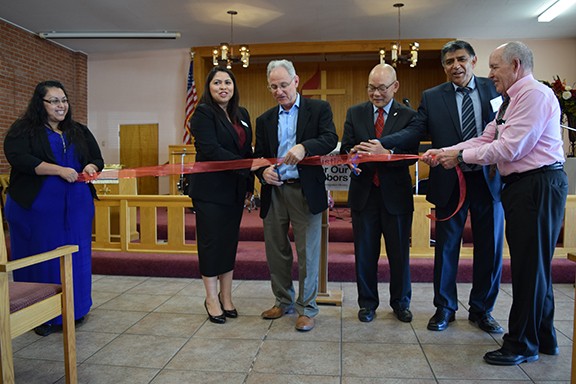 Mayor Jonathan Rothschild, surrounded by Justice For Our Neighbors attorney Ella Rawls, Bishop Robert Hoshibata, Pastor Augustin Jimenez and JFON board members, prepares to cut a symbolic ribbon at the grand opening of the Arizona JFON immigration legal services clinic.